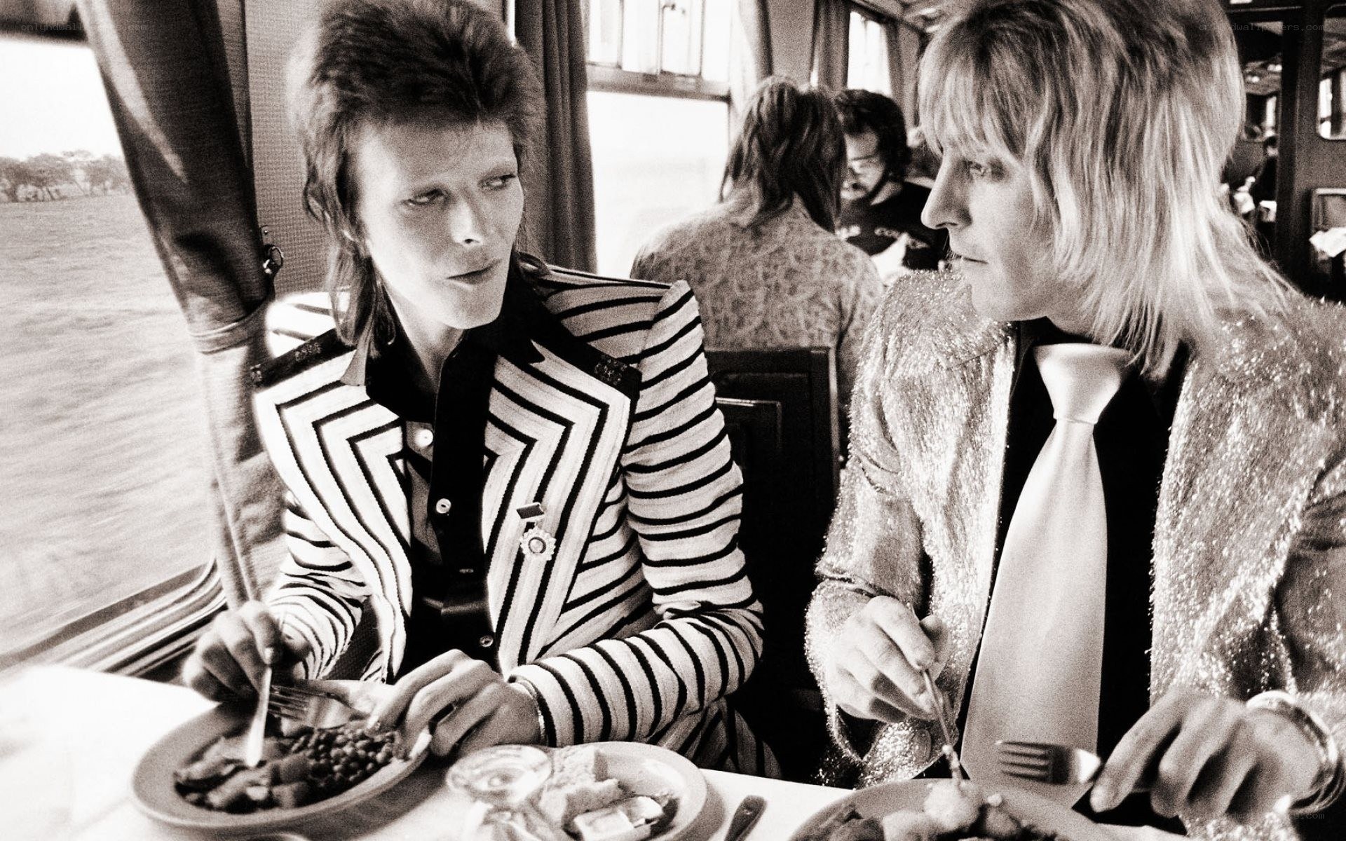 David Bowie and Mick Ronson on a train