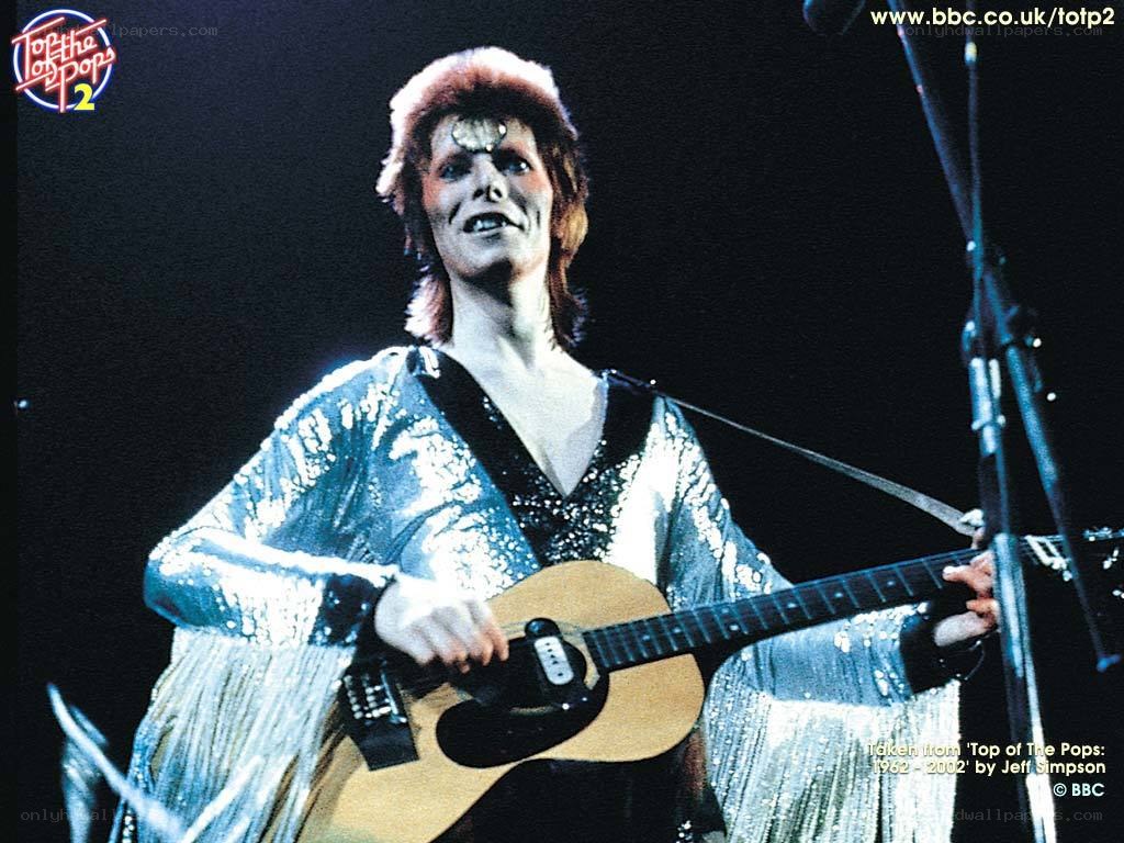 David Bowie on stage with guitar