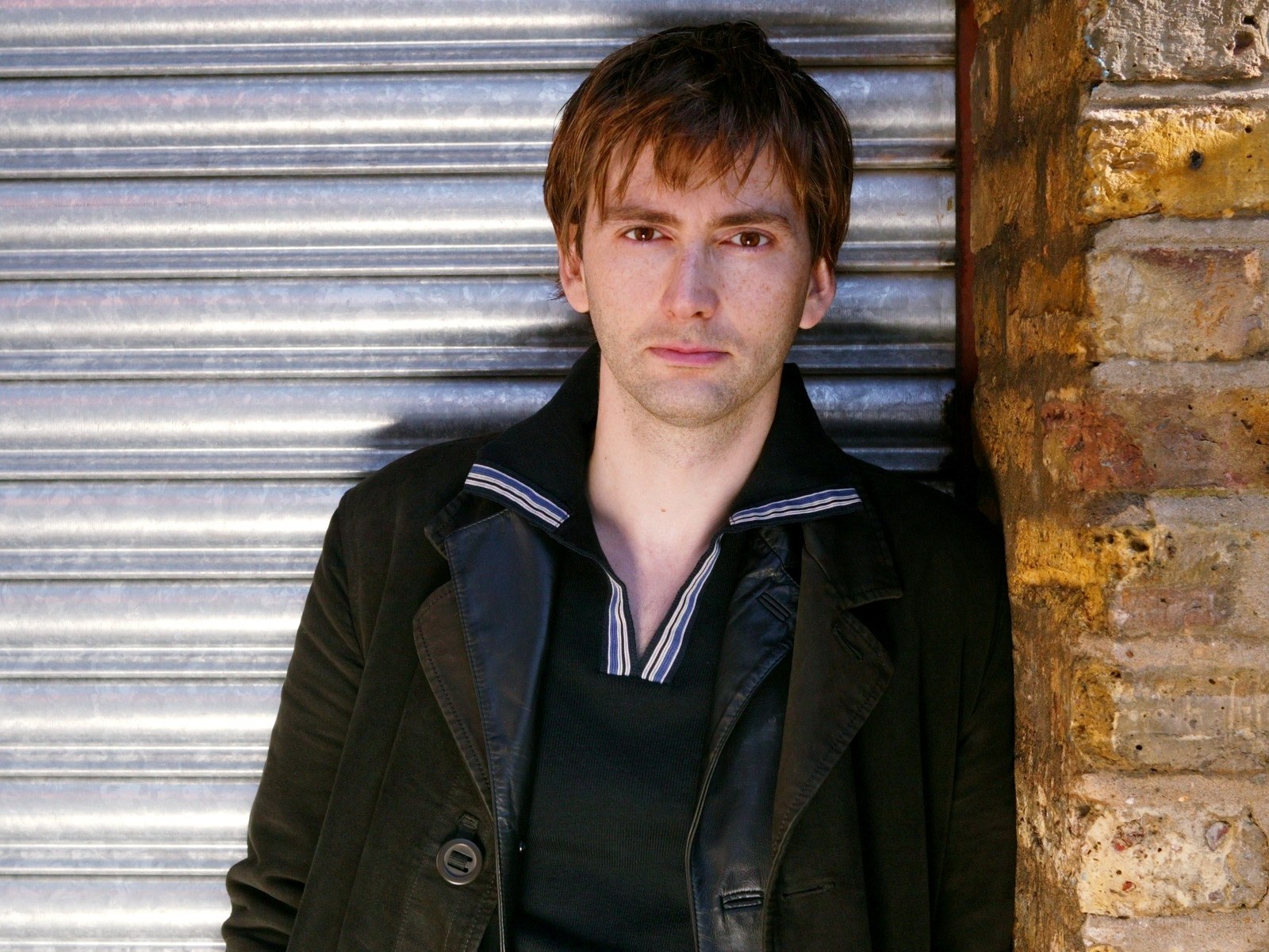 David Tennant leaning against a wall