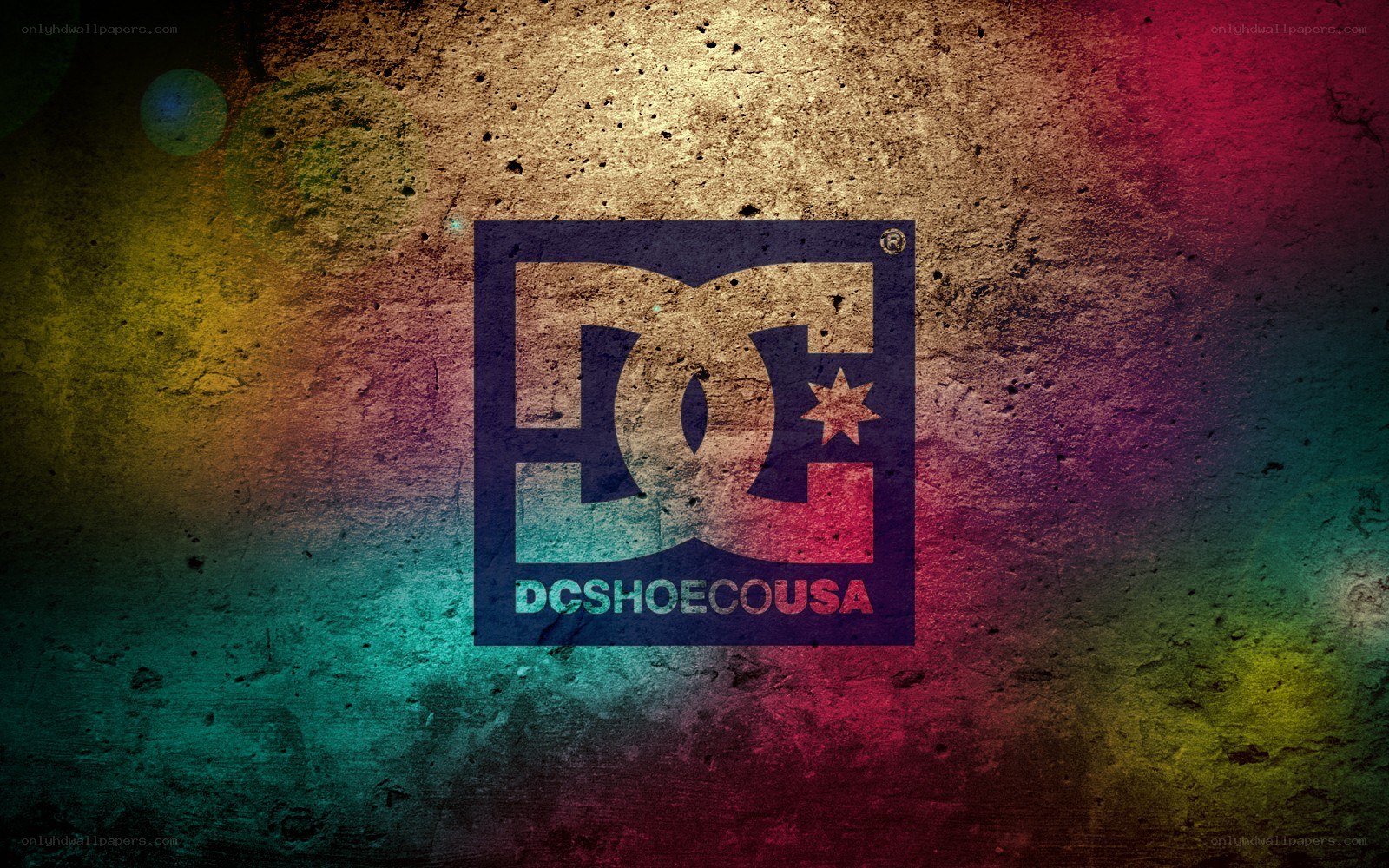 DC Shoes logo on textured wall