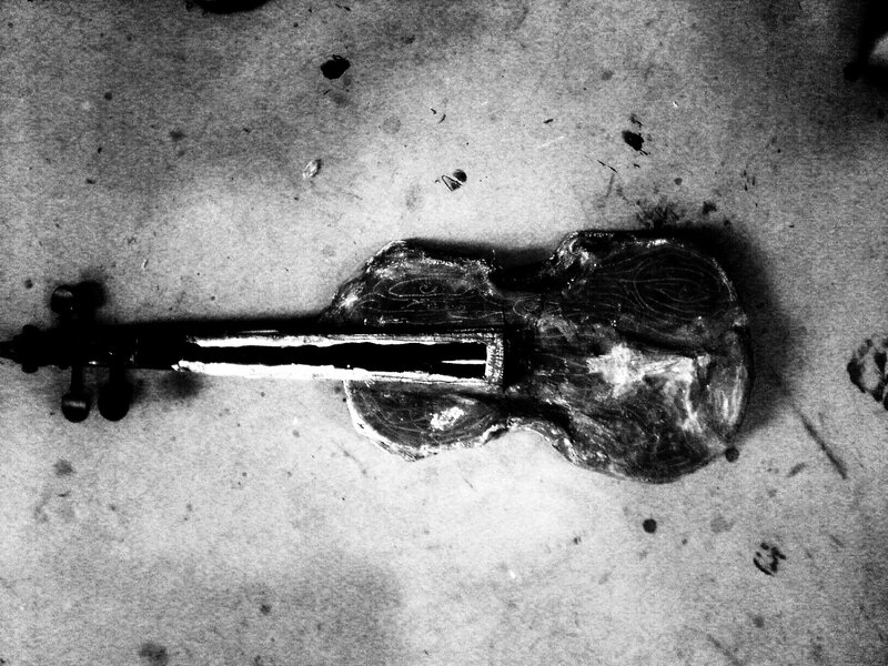 Decayed violin on concrete