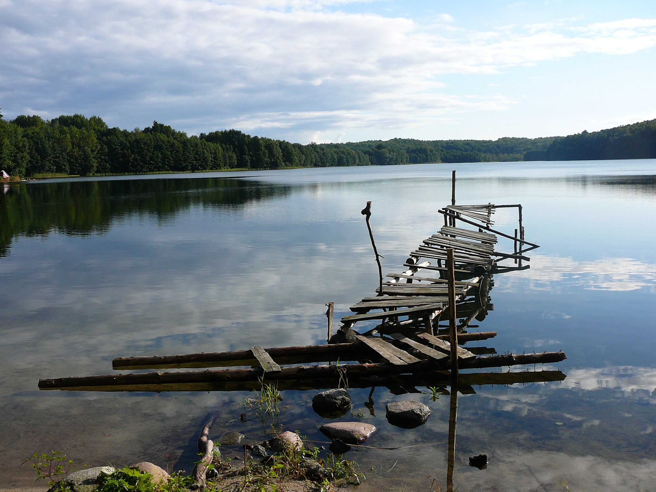 Decaying dock on a calm lake