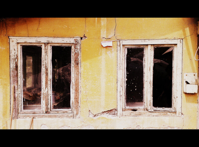 Decaying yellow building facade