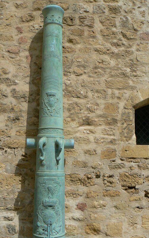 Decorated cannon on stone wall
