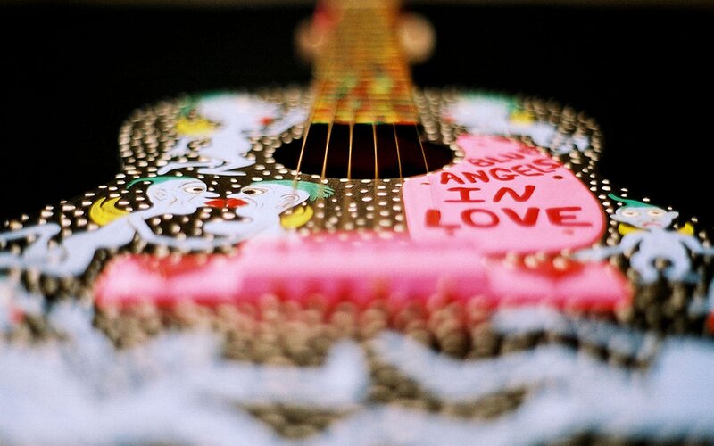 decorated guitar with text