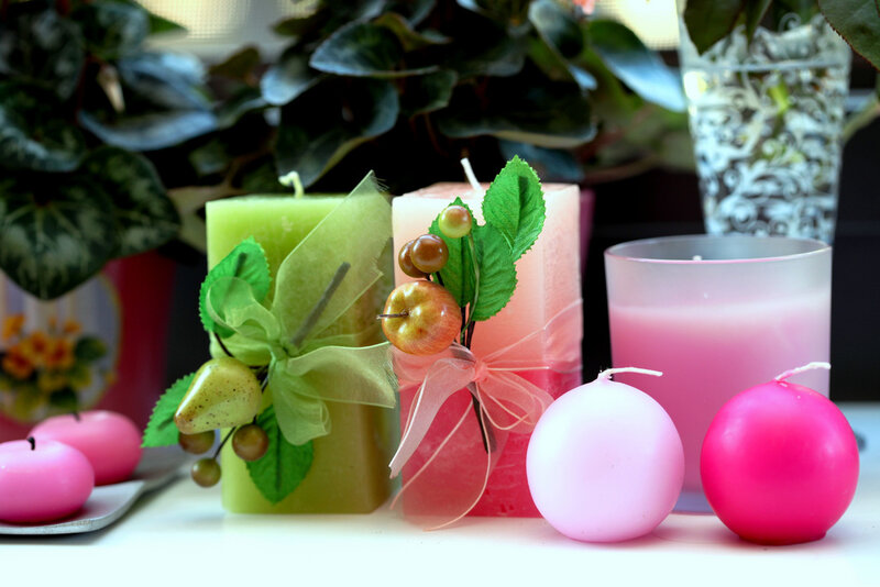 Decorative candles with fruit and leaves