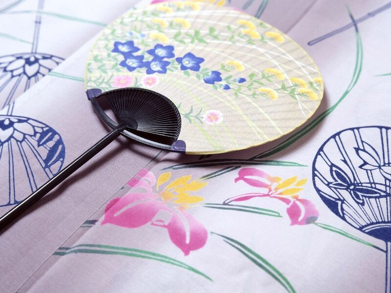 Decorative Japanese fan on floral fabric