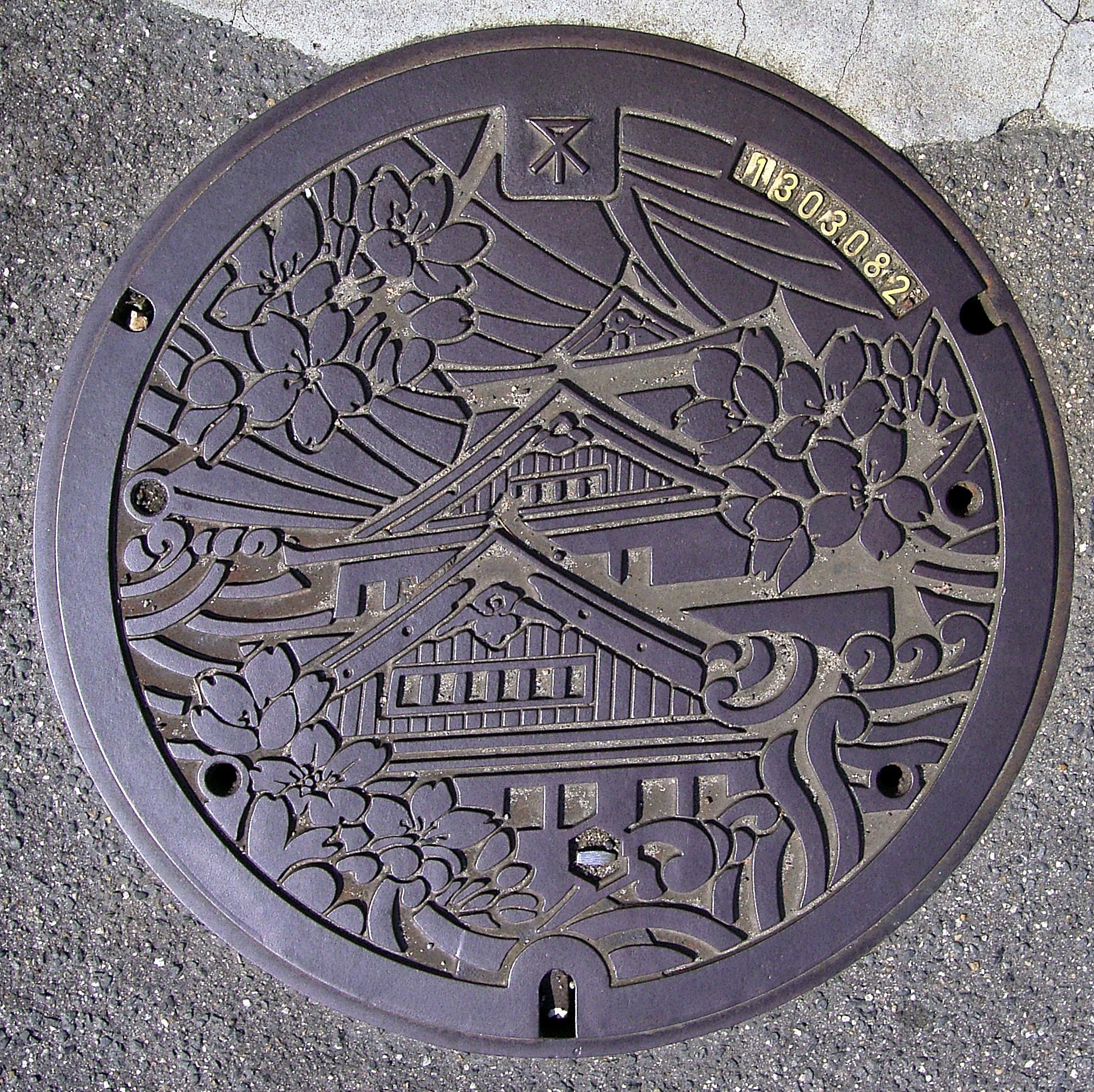 decorative manhole cover with cherry blossoms
