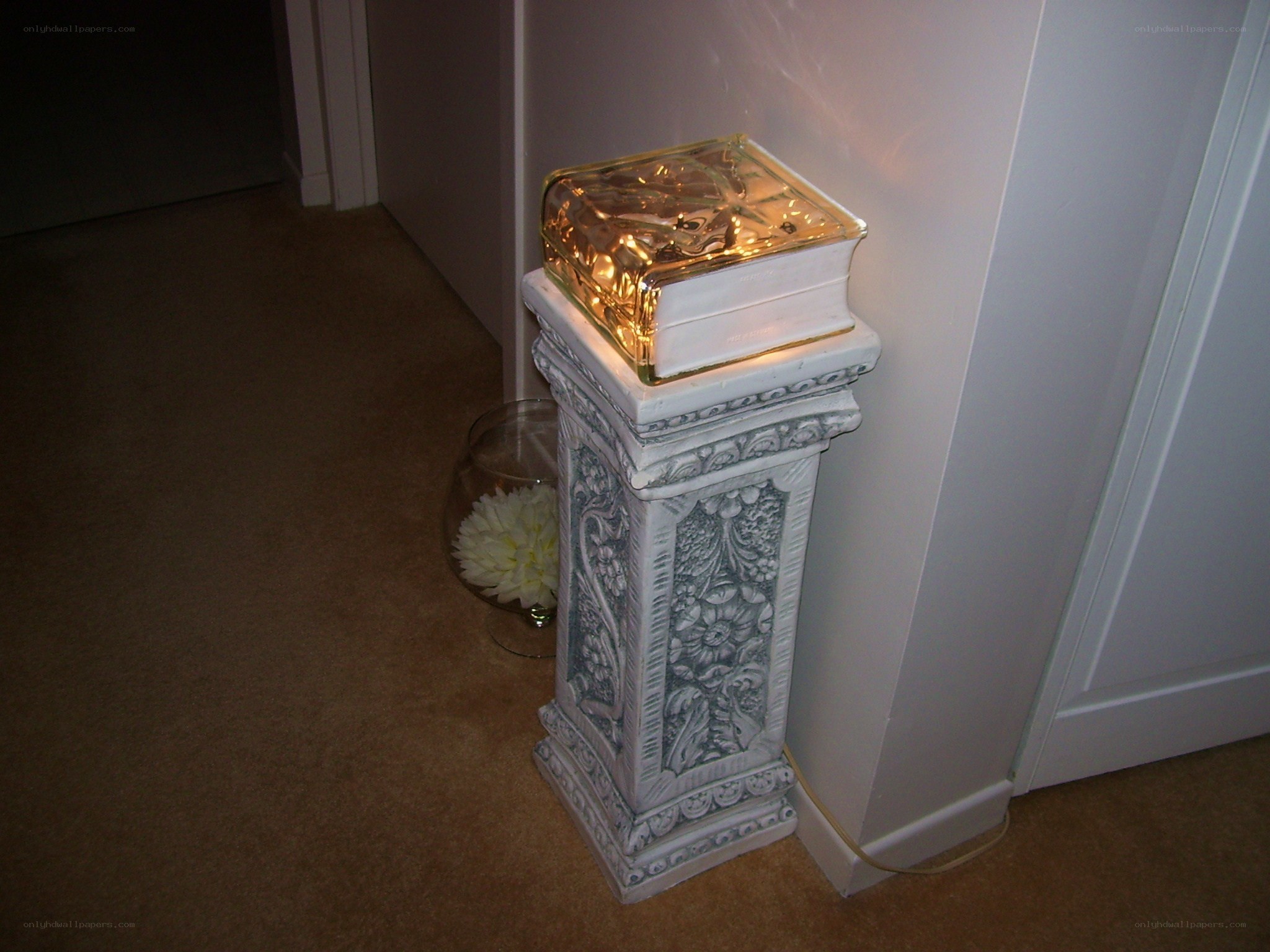 decorative pedestal with lighted book