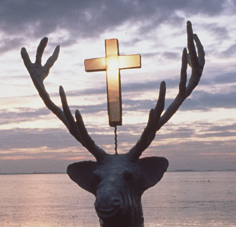 Deer sculpture with cross