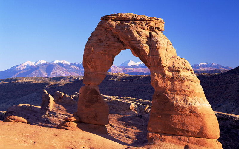 Delicate Arch with snow-capped mountains