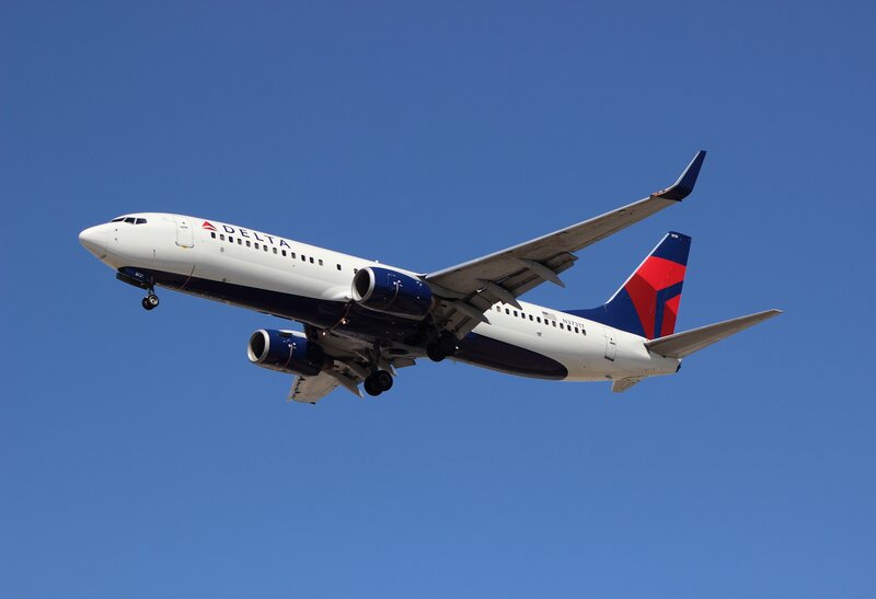 Delta Airplane in Flight — Blue, Clear