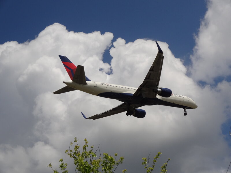 Delta Airplane in Flight — White, Dramatic