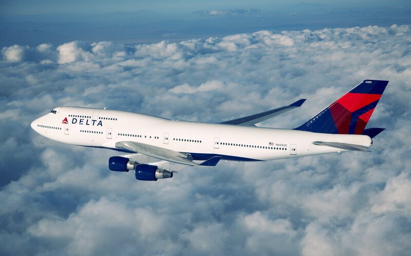 Delta Airplane in Flight — White, Serene