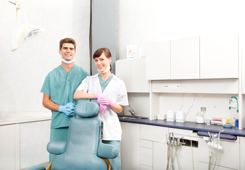 Dentist and assistant in clinic