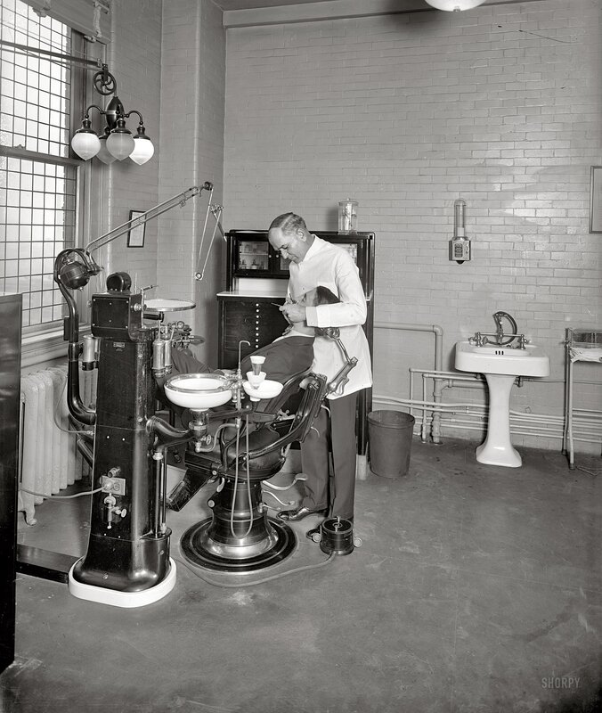 Dentist treating patient in old office