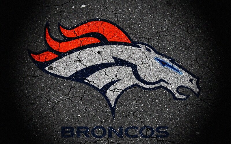 Denver Broncos logo on cracked asphalt