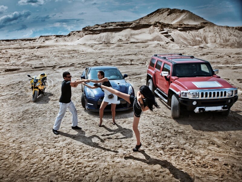 Desert action scene with cars and motorcycle