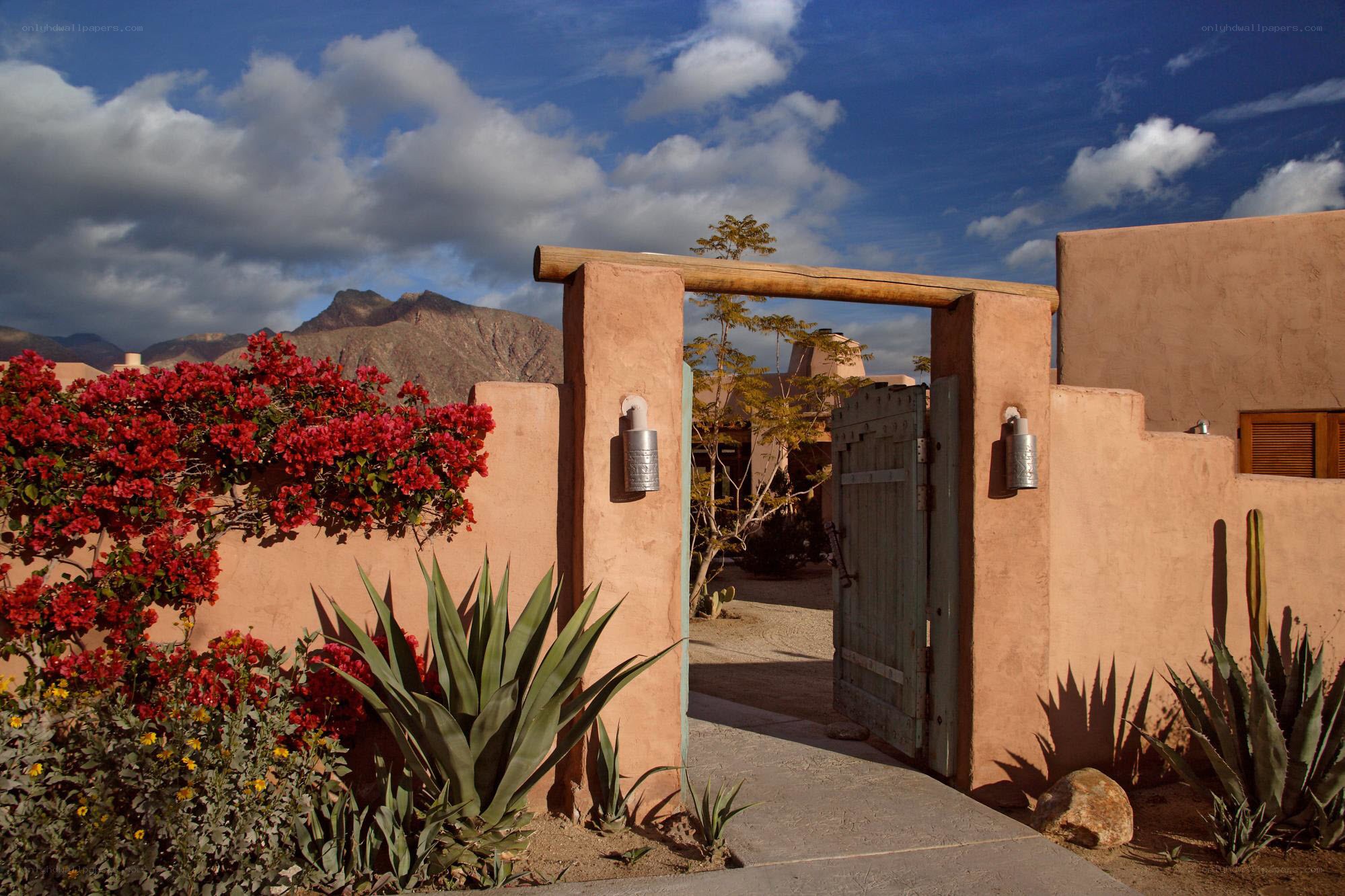 Desert adobe gate with mountains