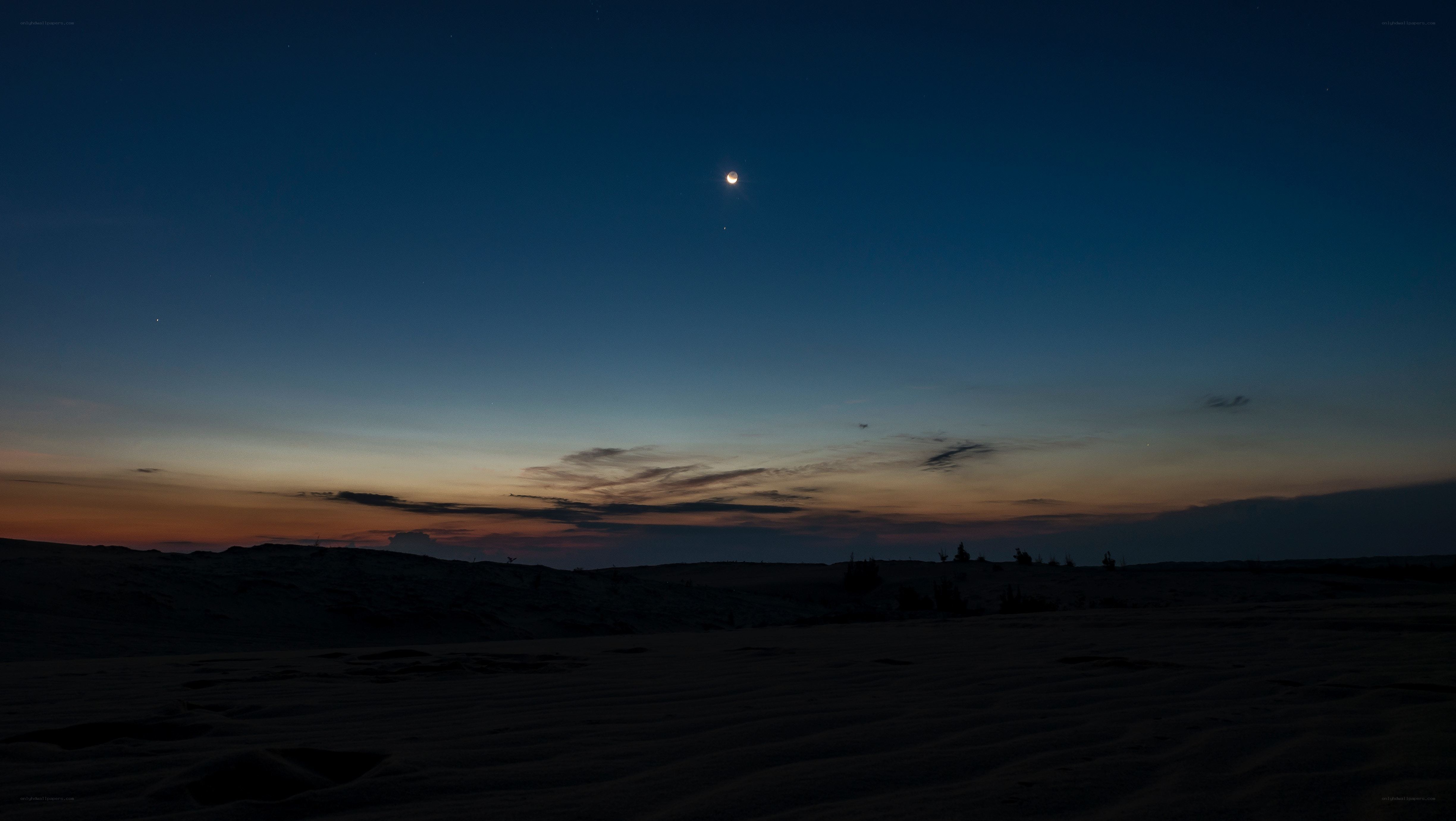 Desert at twilight with moon