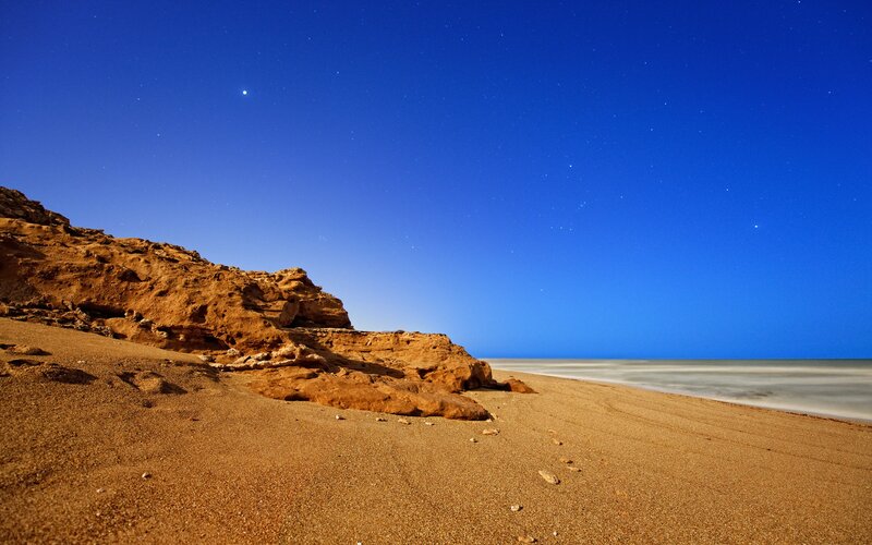 Desert beach under starry sky