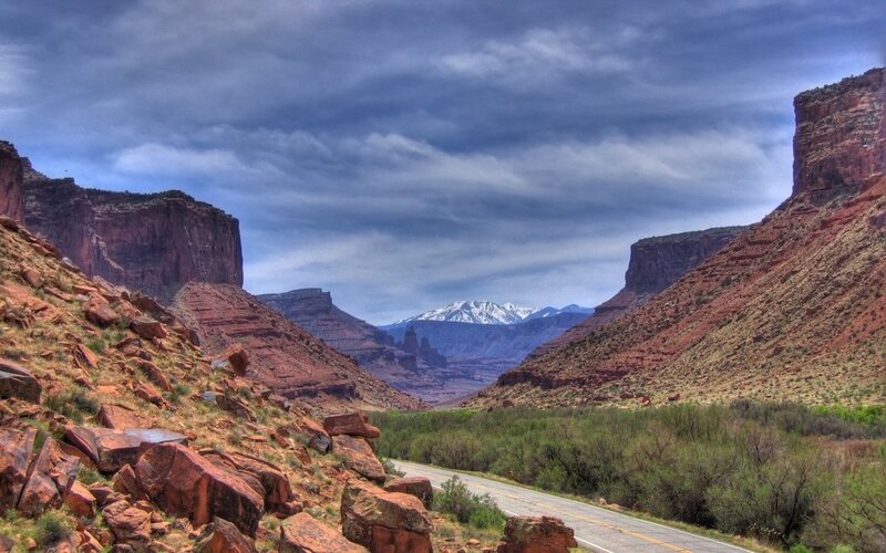 Desert canyon with snow-capped mountains