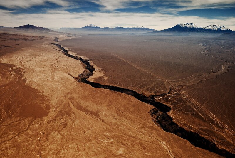 Desert canyon with snow-capped mountains