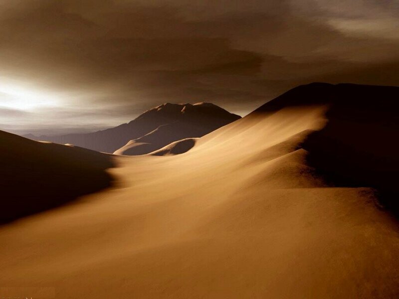 Desert dunes under a cloudy sky