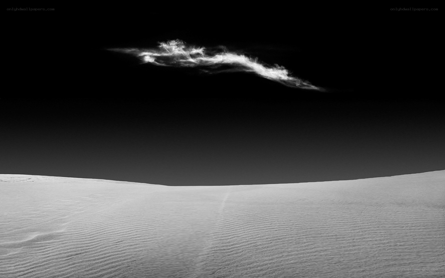 Desert dunes under a solitary cloud