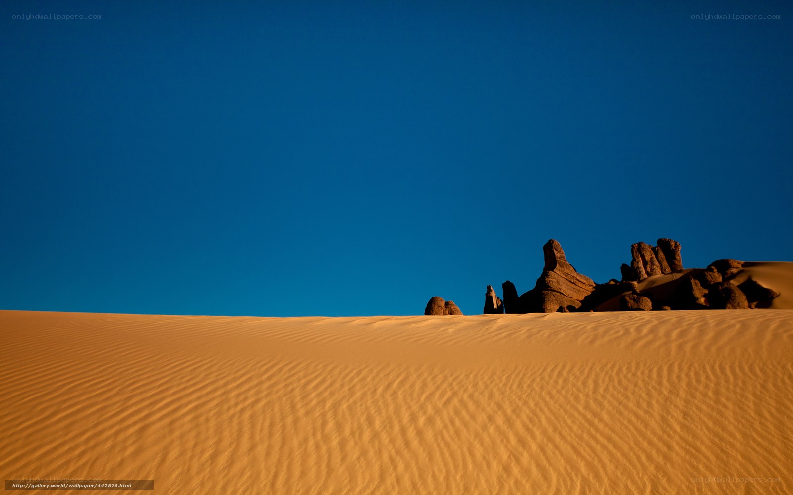 Desert dunes under blue sky