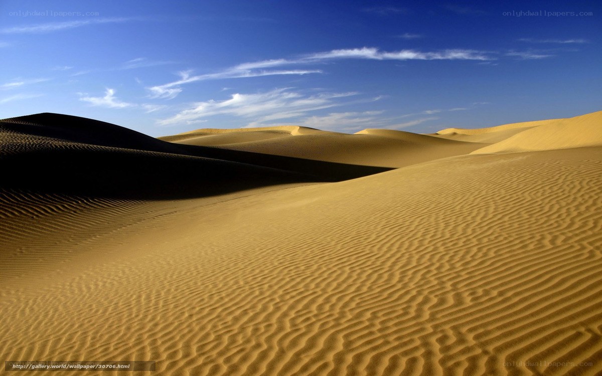 Desert dunes under blue sky