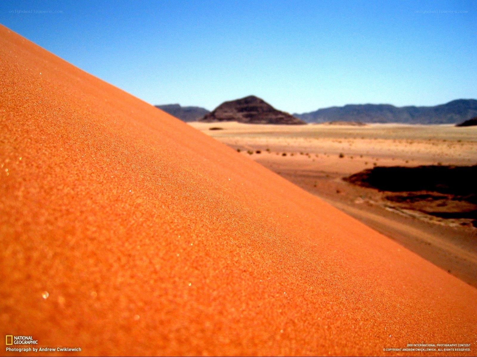 Desert dunes under blue sky