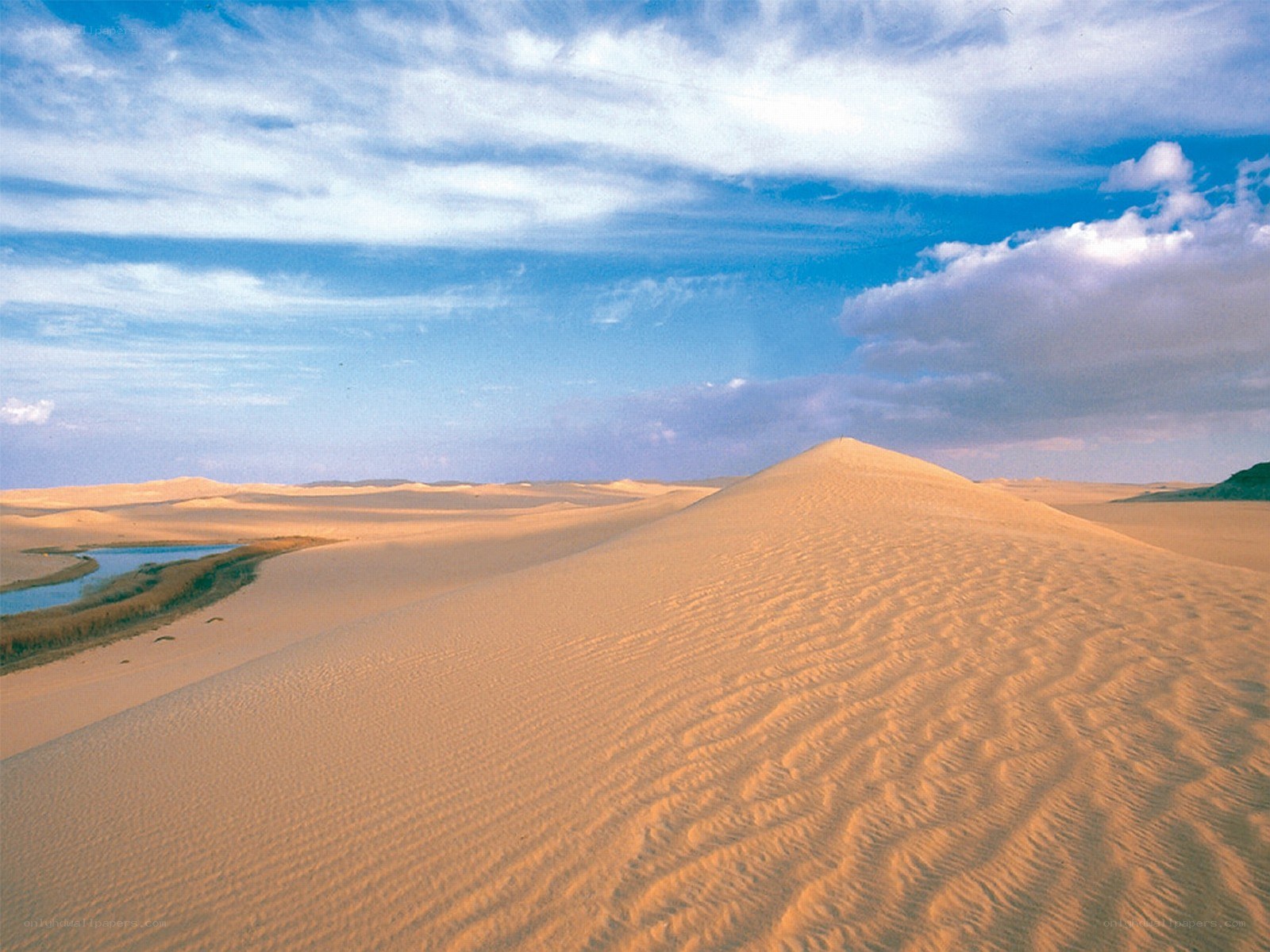 Desert dunes under blue sky