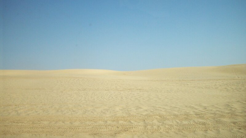 Desert dunes under blue sky
