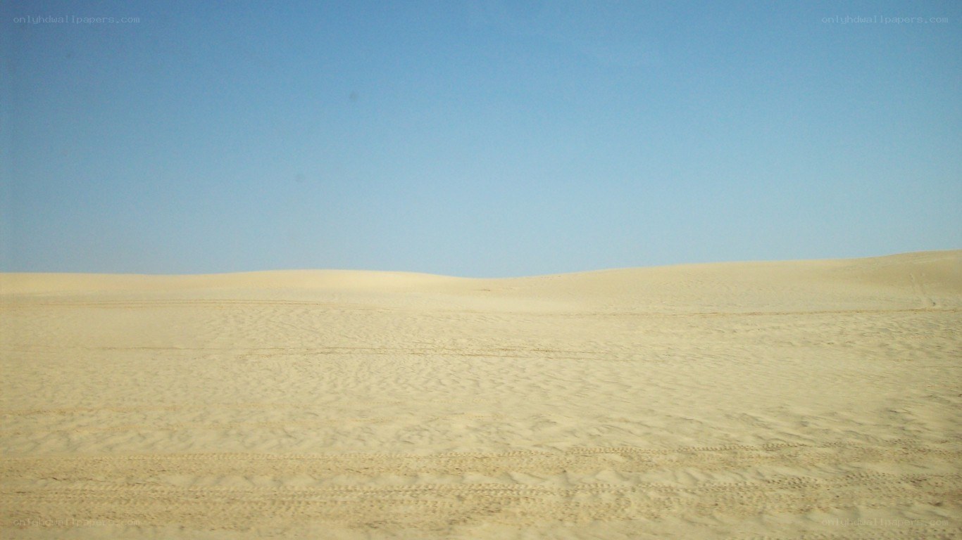 Desert dunes under blue sky