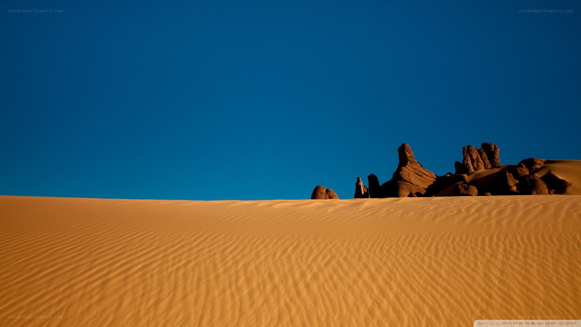 Desert dunes under blue sky