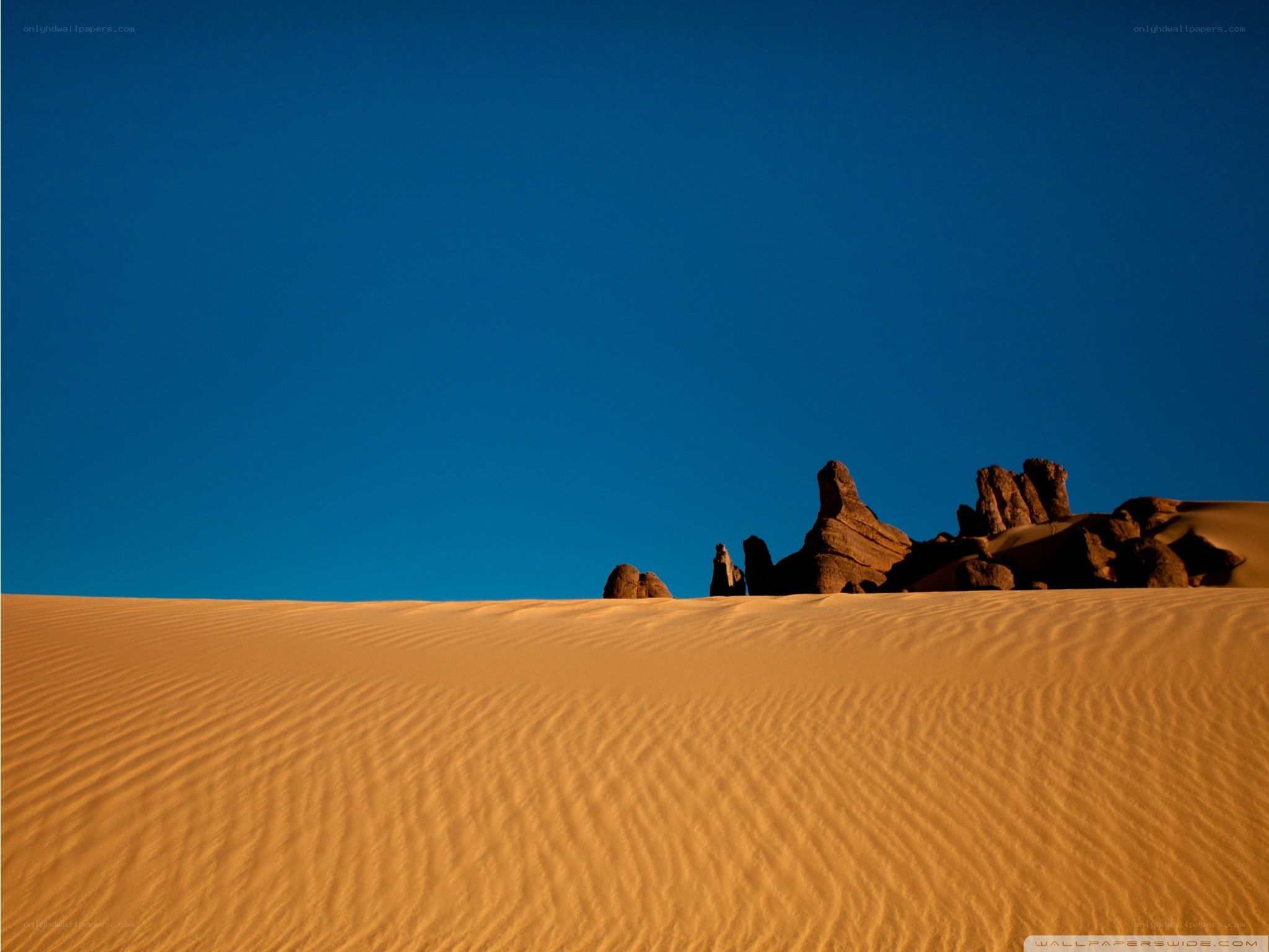 Desert dunes under blue sky