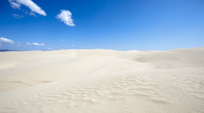 Desert dunes under blue sky