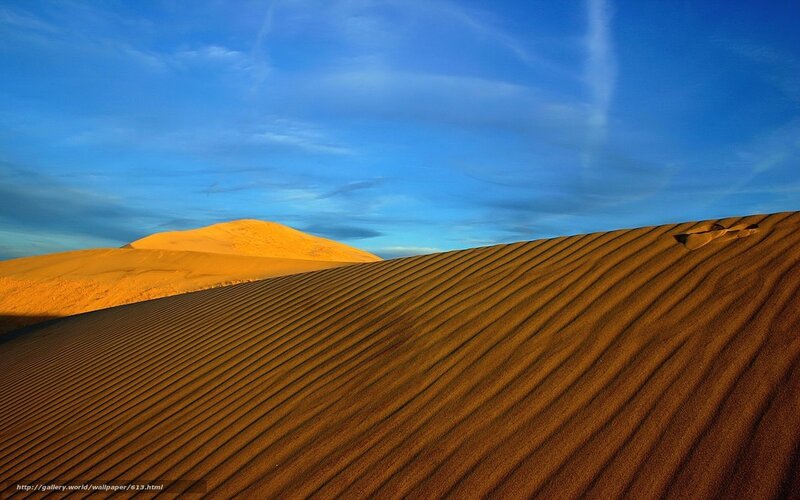 Desert dunes under blue sky