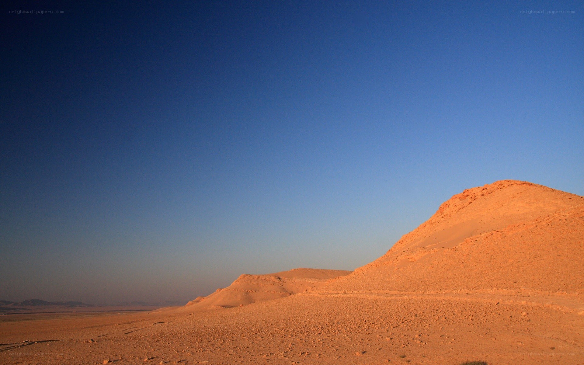 Desert dunes under clear sky