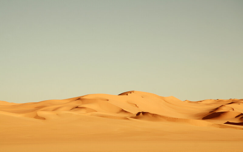 Desert dunes under clear sky