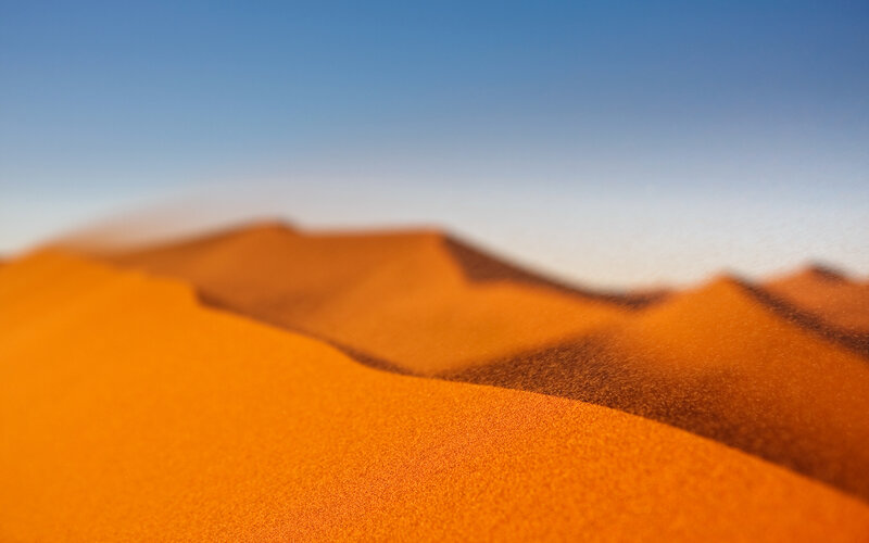 Desert dunes under clear sky