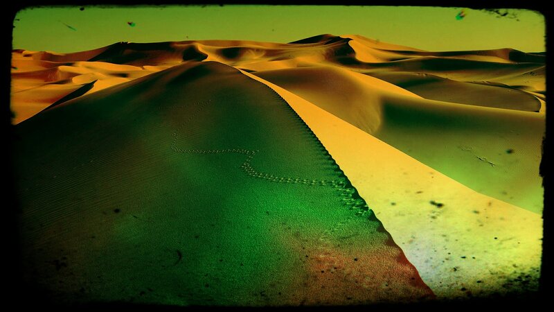 Desert dunes under green light