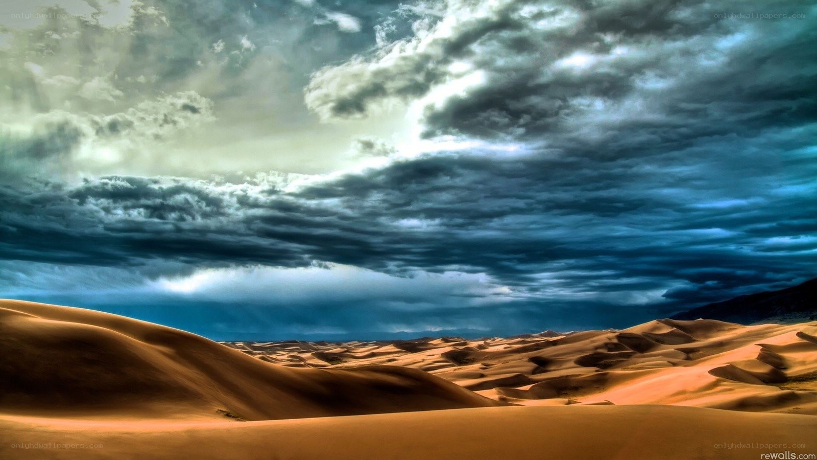 Desert dunes under stormy sky