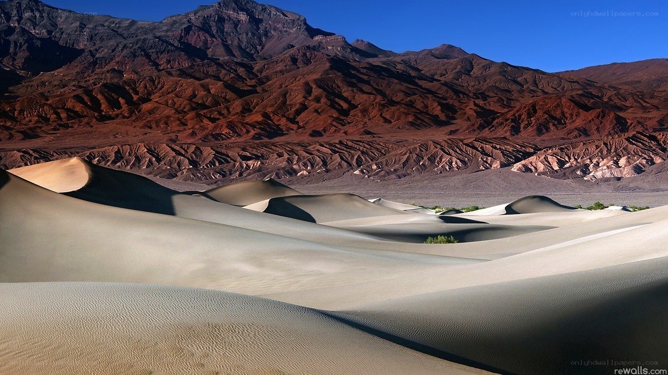Desert dunes with mountains
