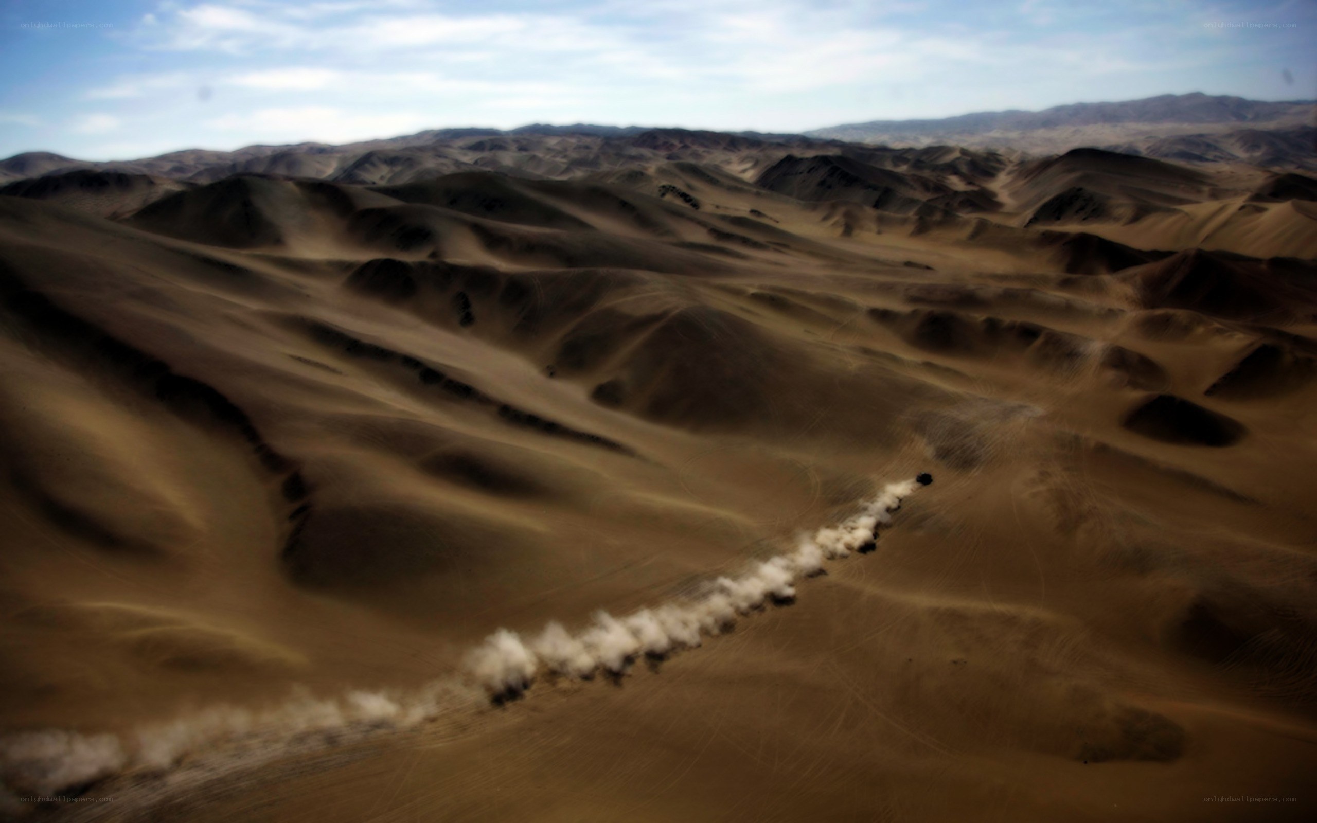 Desert dunes with vehicle trail