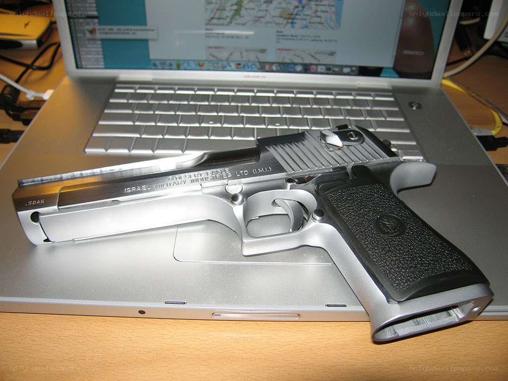 Desert Eagle pistol on laptop