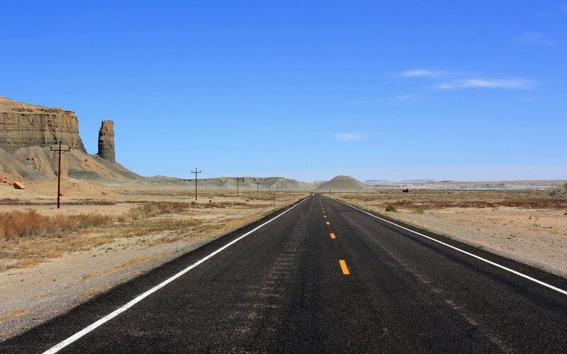 Desert highway under blue sky