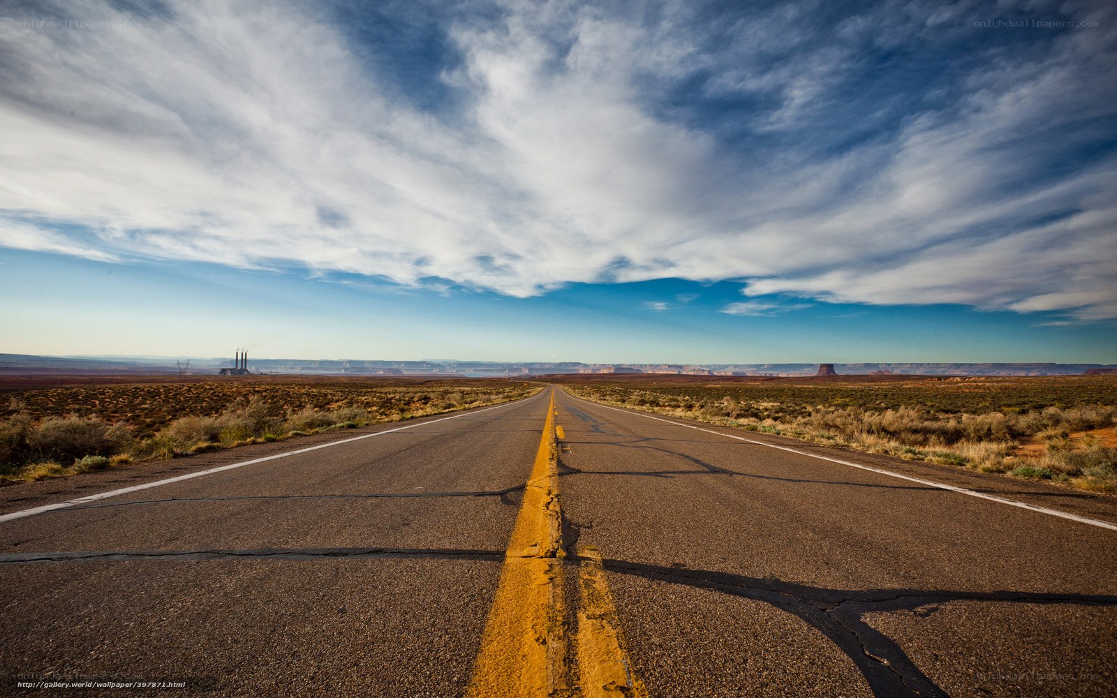 Desert highway under cloudy sky