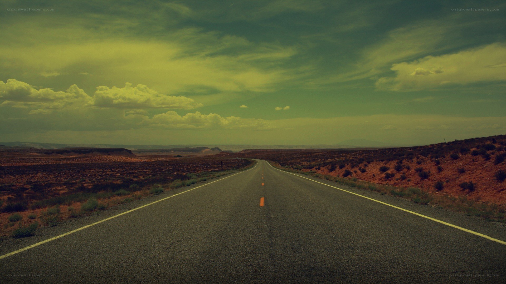 Desert highway under cloudy sky